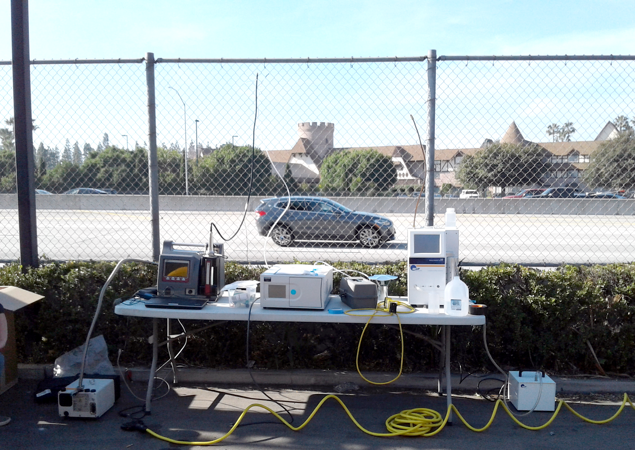 Photograph of the field site, with several instruments in the foreground and the highway in the background 