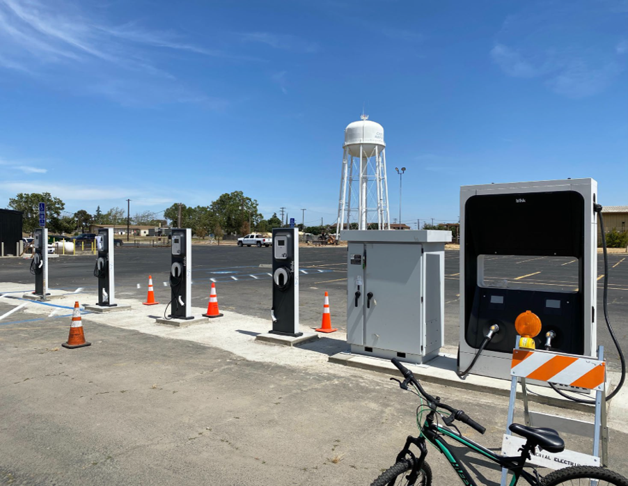 4 public chargers at an open lot charging station and system power unit