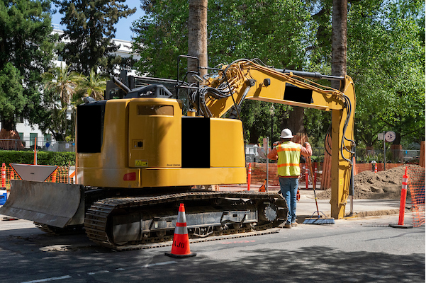 Construction workers work with an excavator at N and 11th streets near Capitol Park in Sacramento. April 6, 2022