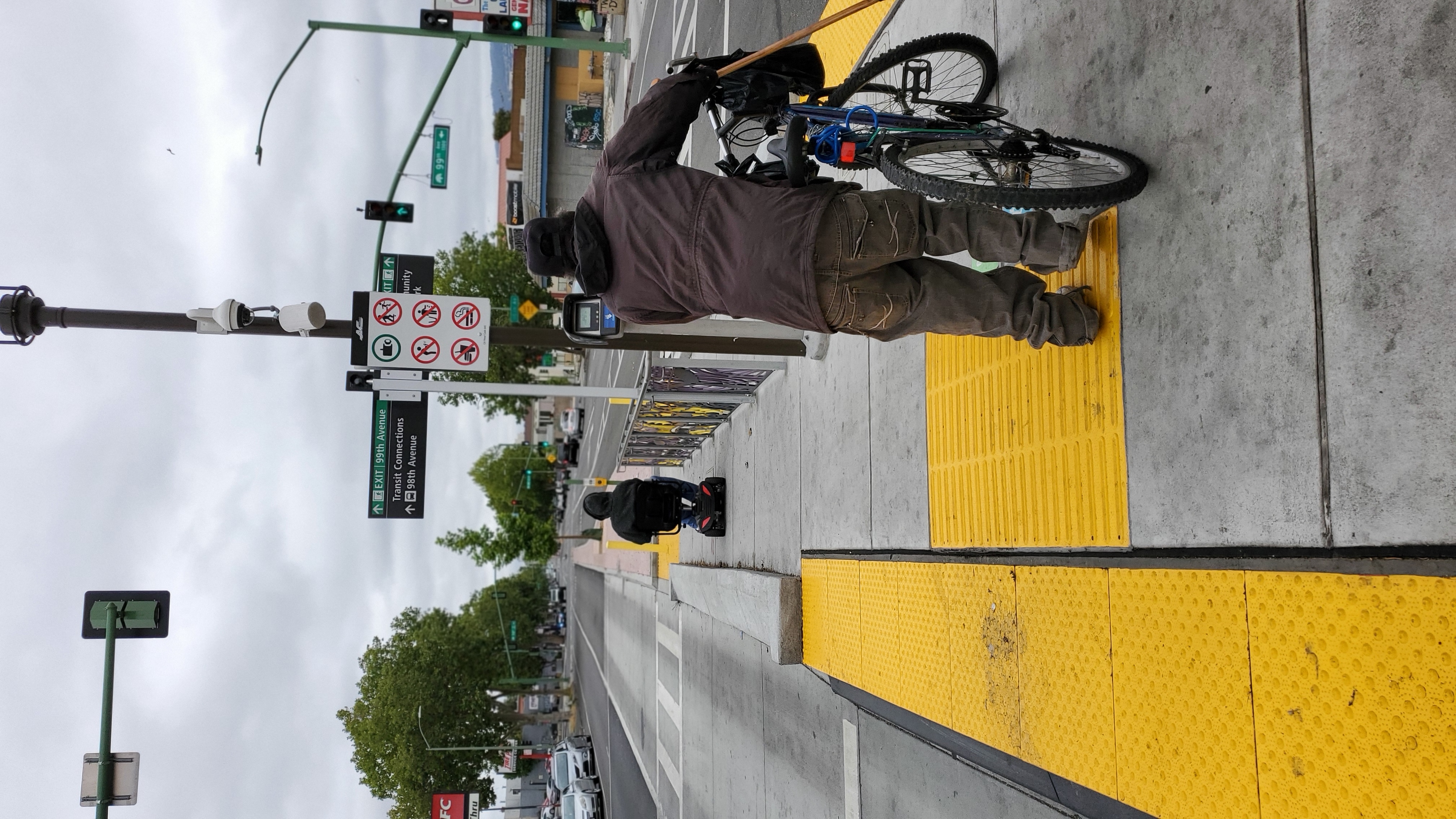 Resident walking bike on street