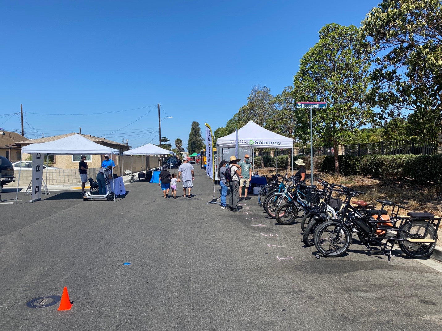 A variety of e bikes and scooters on display and at an outdoor mobility demonstration project