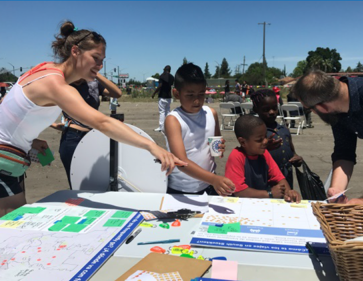Stockton residents participate in a community mapping exercise at an outdoor community event