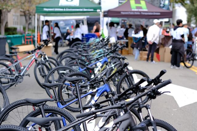 Bikes lined up in front of booths at Bike Give Away event.