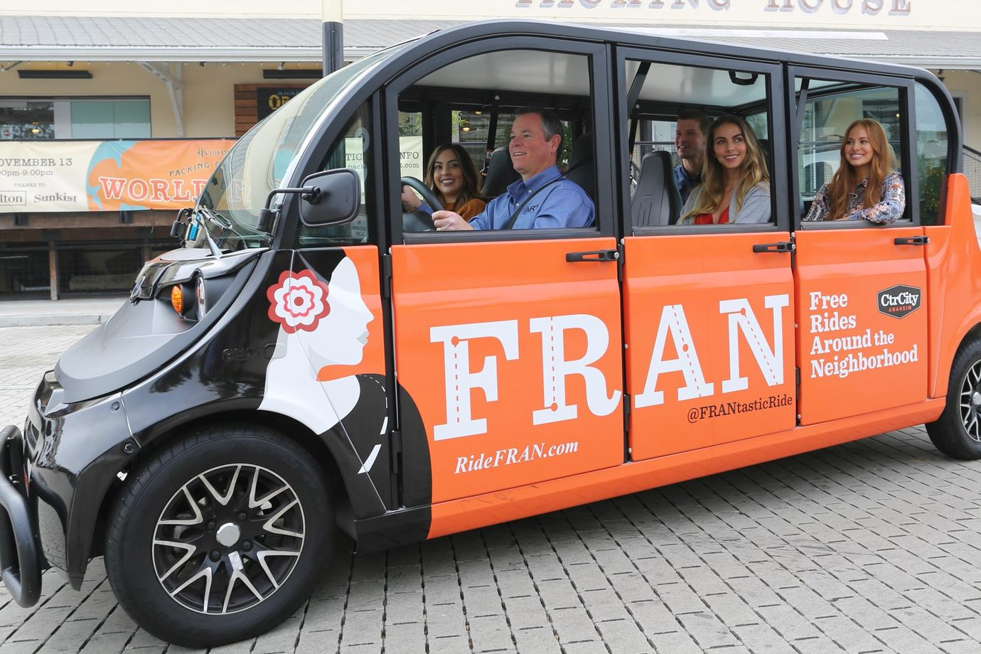 People riding in Free Rides Around the Neighborhood– FRAN electric vehicle 