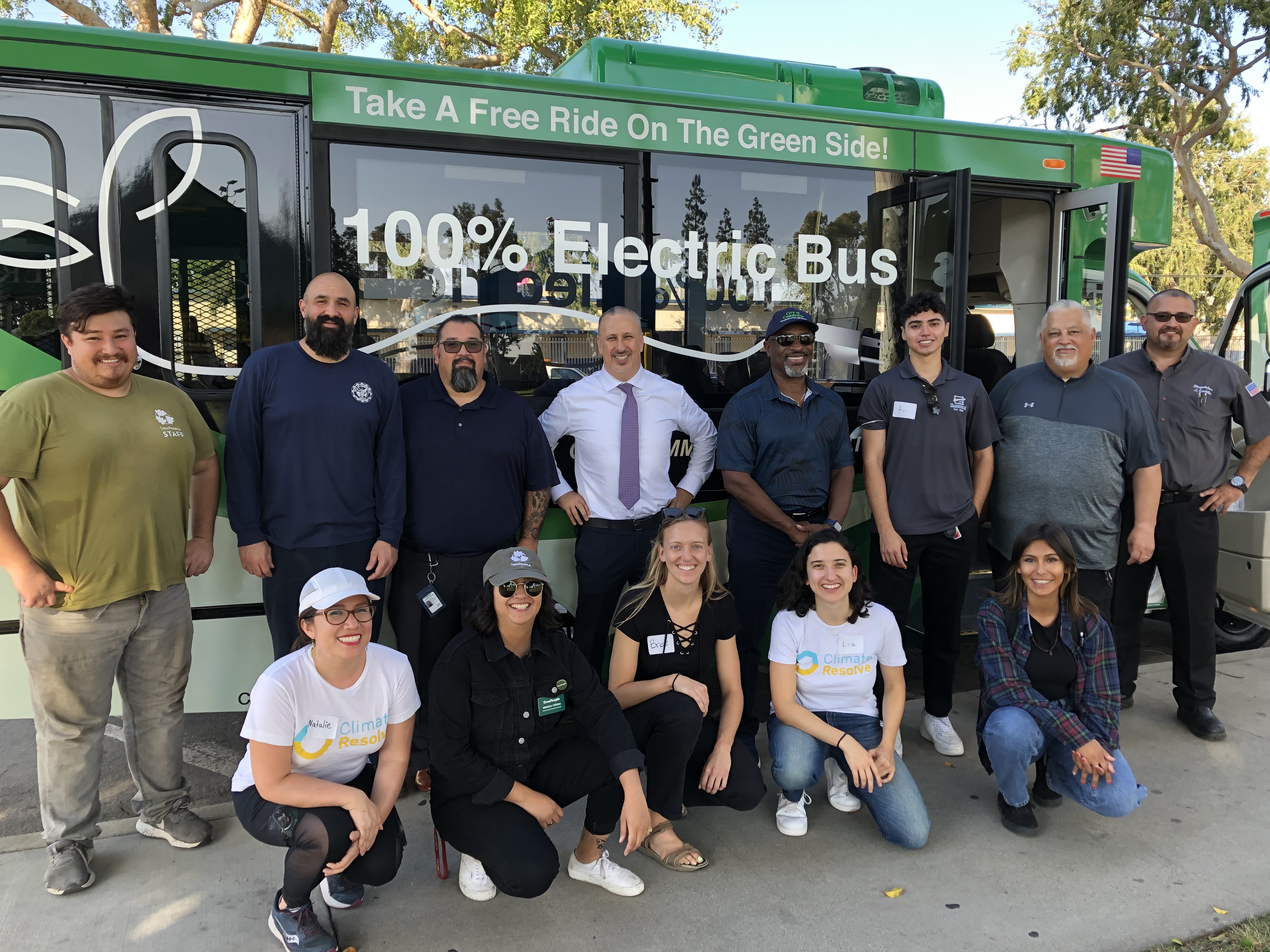 Event participants standing in front of zero-emission bus