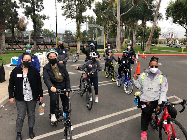 Event participants on bikes in a parking lot