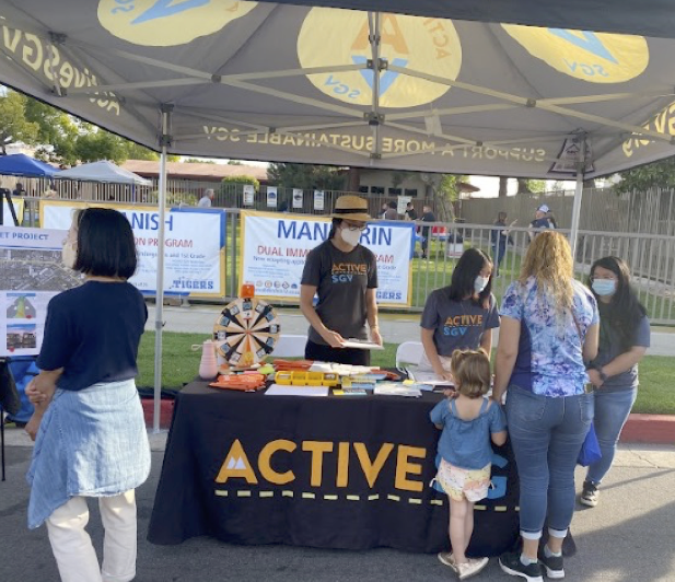 Active SGV booth and volunteer handing out materials at project event