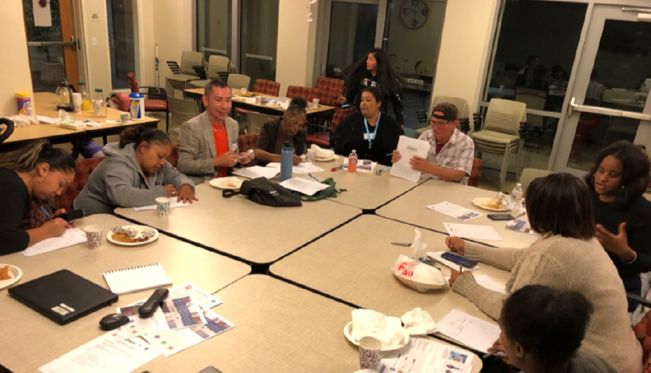 Lion Creek Crossings (Oakland) Site Level Team Meeting, team members sitting at tables