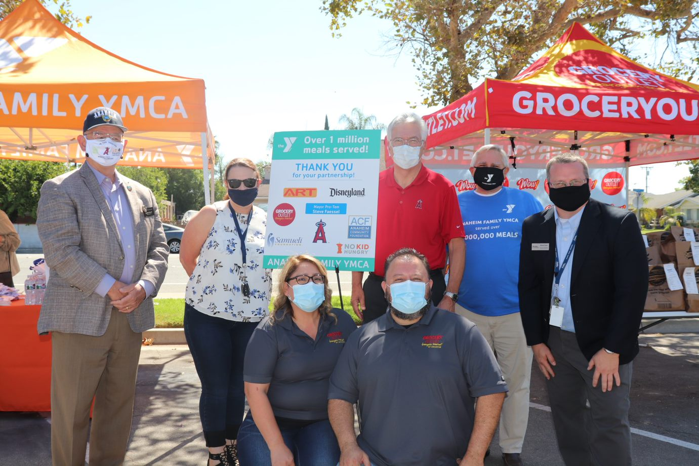 YMCA Community Engagement Event Participants posing masked in front of project signs