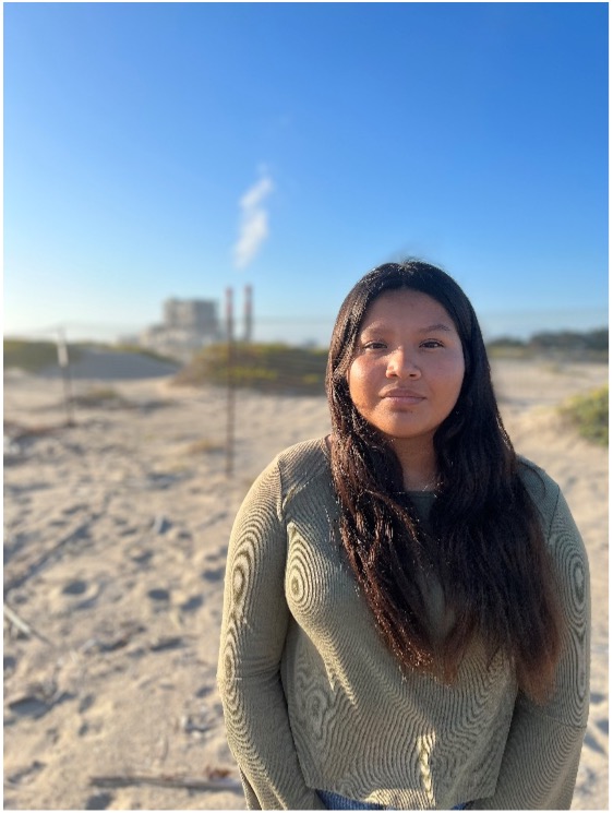 Figure 1: CAUSE youth leader from South Oxnard standing in front of the Ormond Beach Generating Station.
