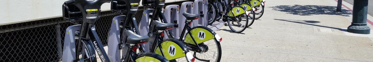 A row of parked bikeshare bicycles