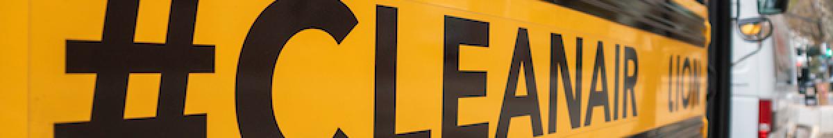 Hashtag #CLEANAIR on closeup of side of electric school bus