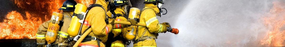 4 firefighters holding hose