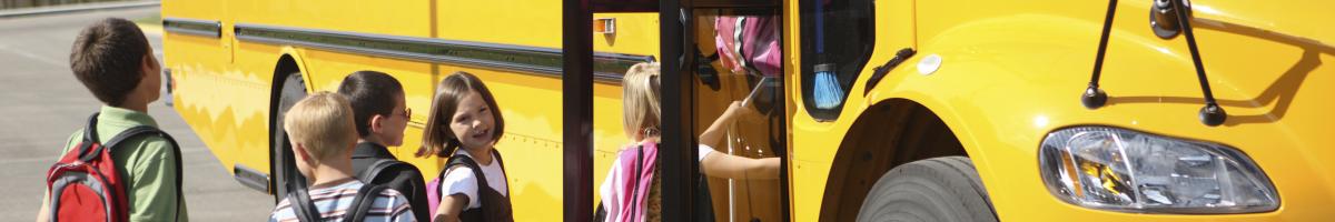 children getting into school bus