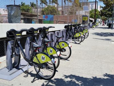 A row of parked bikeshare bicycles